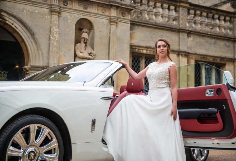 Rolls-Royce Dawn with bride posing next to it