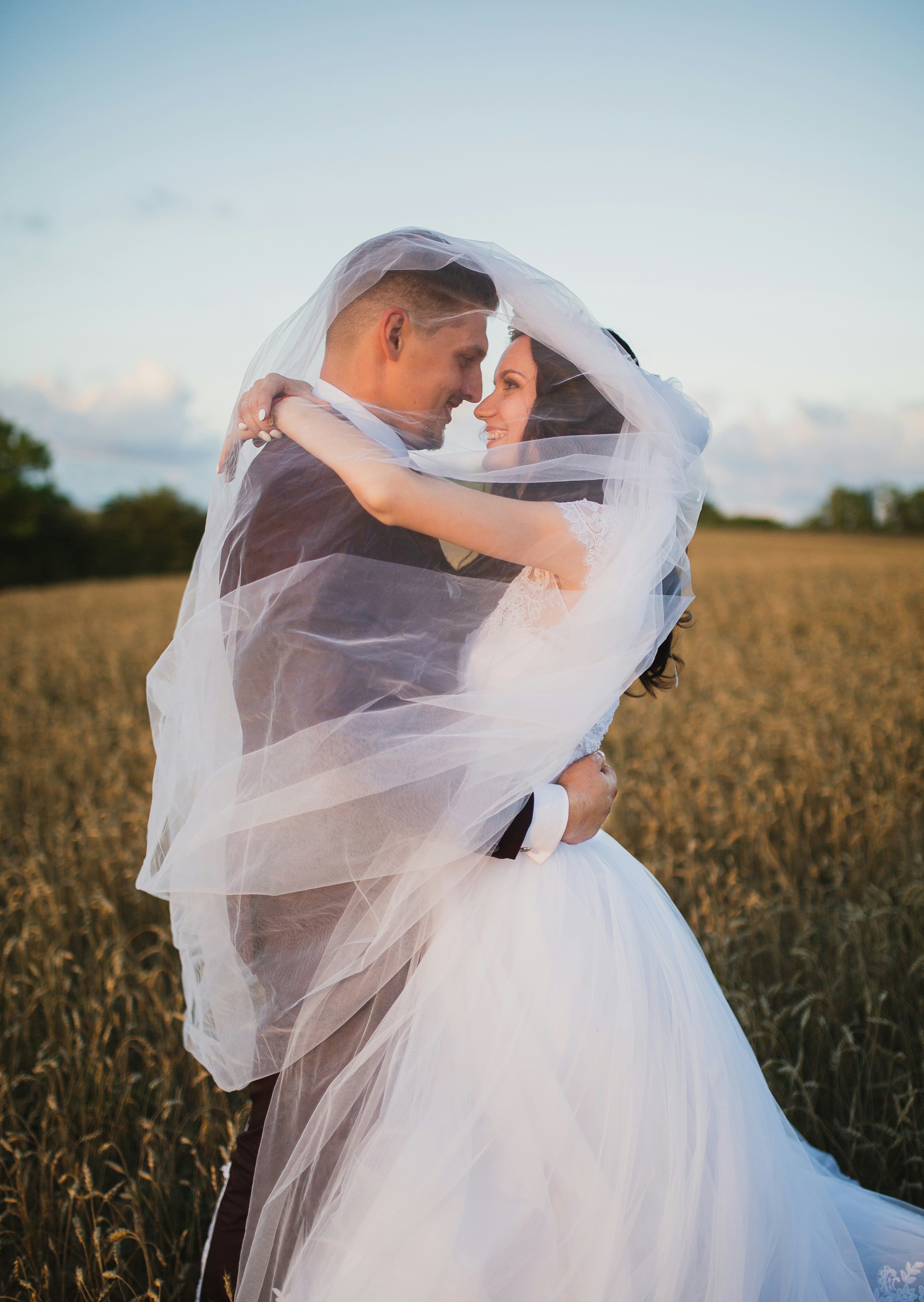 couple at wedding photoshoot in field