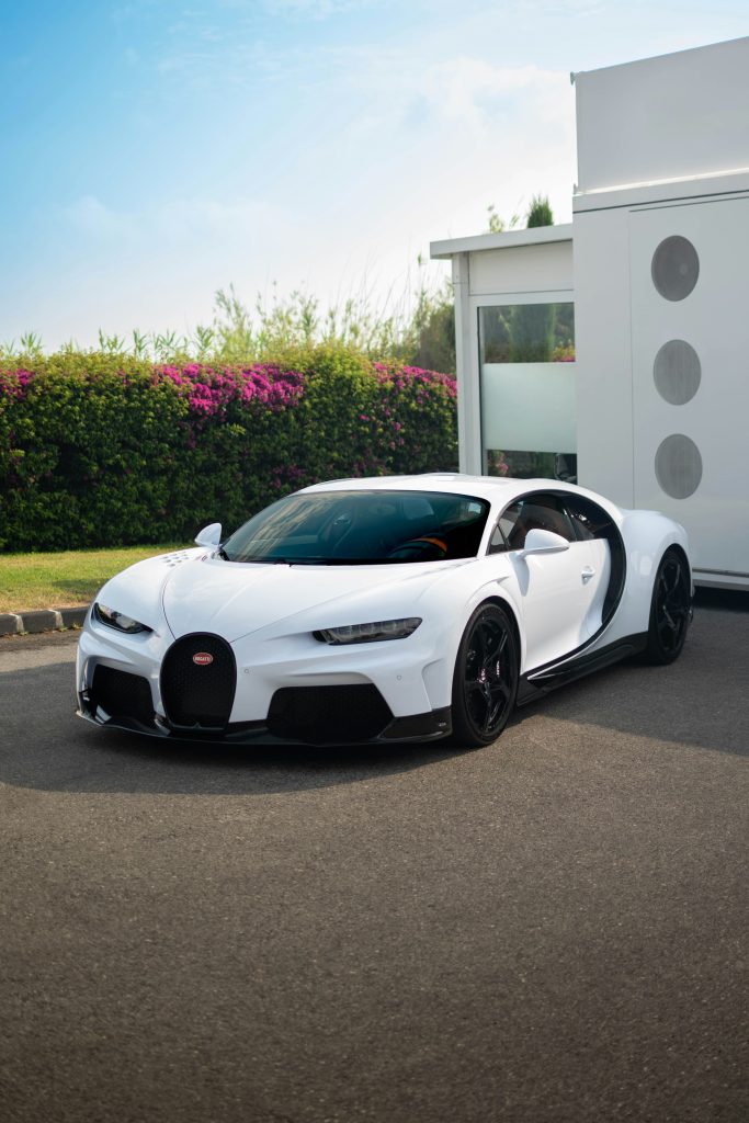 White Bugatti Chiron book parked outside white house