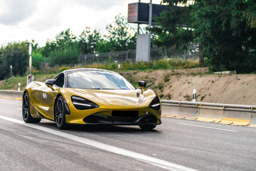 McClaren 720S car driving down a road