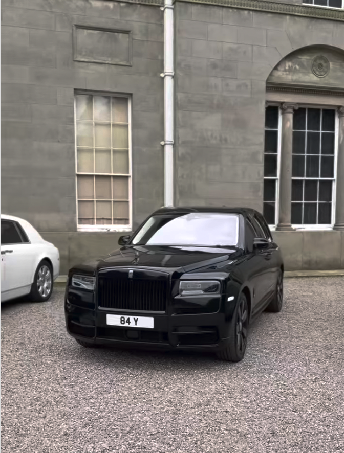 Black Rolls-Royce CUllinan parked outside wedding venue