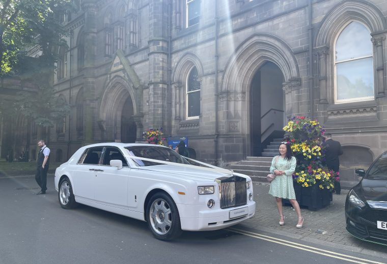 couple posing in front of Rolls-Royce Phantom wedding car